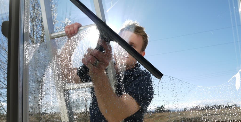 Professional window cleaner at work